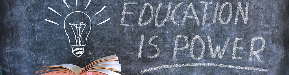 ©istock\thomas-bethge Bücher und Tafel mit Zeichnung einer Glühbirne und Slogan Bildung ist Kraft, Lernen, Wissen, Zurück zur Schule Konzept